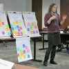 A student explains several post-it boards.