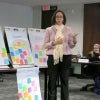 A woman shows her post-it presentation