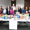Volunteers gather around a table of donated items