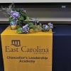 A table with a custom tablecloth that reads 'Chancellor's Leadership Academy'