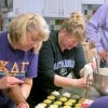 Volunteers make muffins in the kitchen